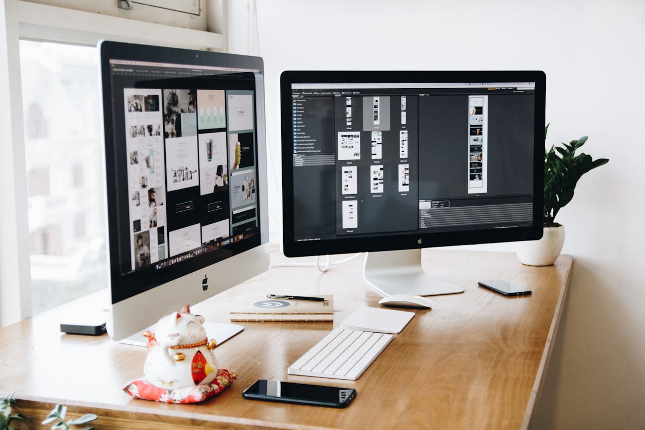 creative A well-organized design workspace with dual monitors and design software on display.